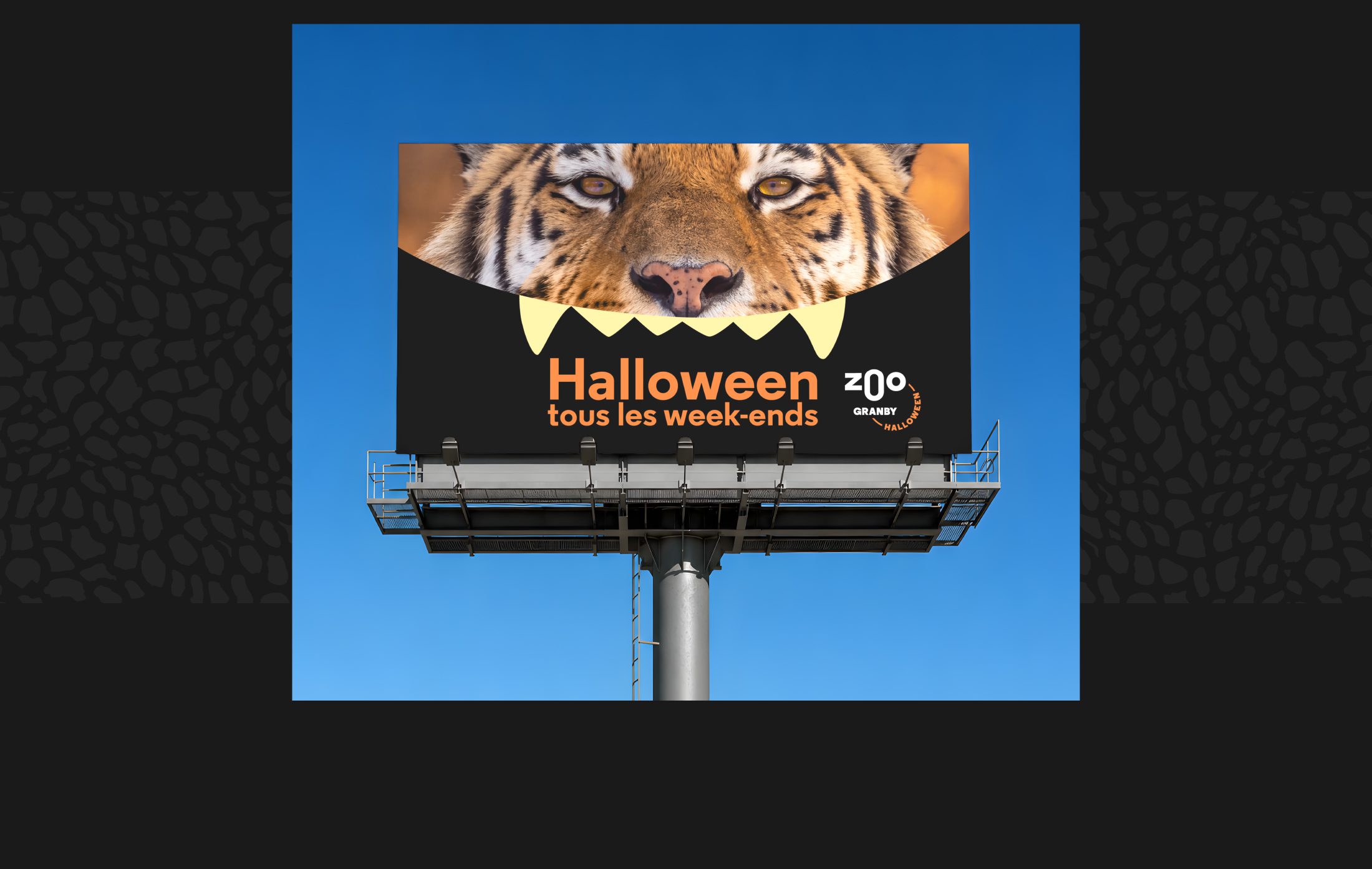 Billboard showing a tiger's face with a large teeth motif and the text 'Halloween tous les week-ends' for Zoo Granby.